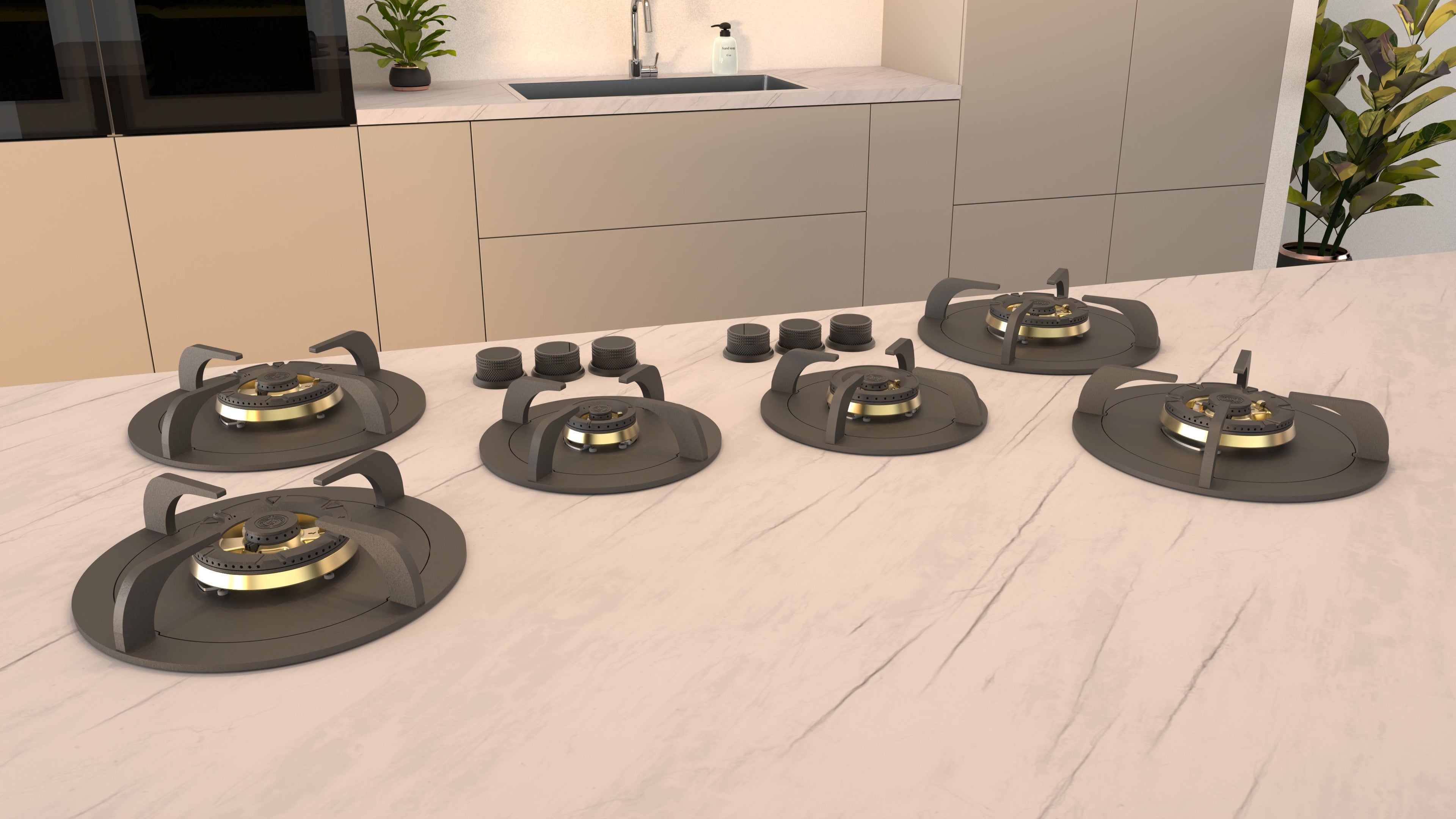 Five VARIOCOOK  stovetop burners with brass burner caps arranged on a white marble kitchen countertop, with a modern beige kitchen cabinetry background.